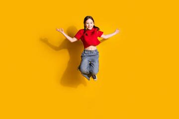 Sticker - Full length portrait of cute little girl jump meditate wear t-shirt isolated on yellow color background