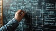 © Kanin - Hand drawing data flow diagram on a blackboard. Concept of planning, strategy, and organization in software development and business management.
