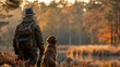 © asayenka - a hunter accompanied by their loyal dog amidst a forest at dawn. The golden hour light adds warmth and depth to this peaceful scene of companionship and anticipation.