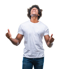 Wall Mural - Afro american man over isolated background crazy and mad shouting and yelling with aggressive expression and arms raised. Frustration concept.