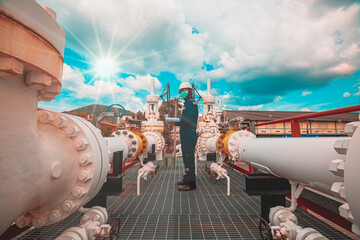 Wall Mural - Male worker inspection at steel long pipes and pipe elbow in station oil factory during refinery valve of visual check record pipeline tank