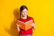 © deagreez - Portrait of cute little girl read book empty space wear t-shirt isolated on yellow color background
