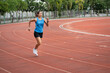© chachamp - Asia mature woman Runner drill training on race track and field