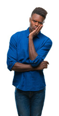 Poster - Young african american man over isolated background thinking looking tired and bored with depression problems with crossed arms.