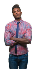 Canvas Print - Young african american business man over isolated background skeptic and nervous, disapproving expression on face with crossed arms. Negative person.