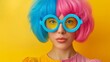© Nataliia_Trushchenko - A woman with blue and pink hair and blue glasses. She is wearing a yellow shirt. The image has a fun and playful mood