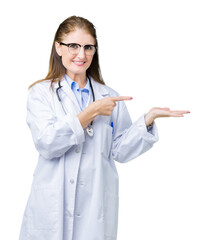 Poster - Middle age mature doctor woman wearing medical coat over isolated background amazed and smiling to the camera while presenting with hand and pointing with finger.