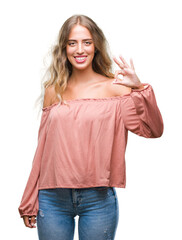 Wall Mural - Beautiful young blonde woman over isolated background smiling positive doing ok sign with hand and fingers. Successful expression.