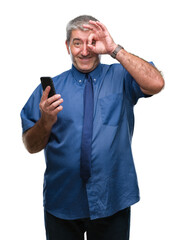 Wall Mural - Handsome senior man texting sending message using smartphone over isolated background with happy face smiling doing ok sign with hand on eye looking through fingers