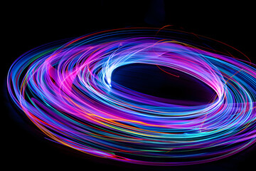 Wall Mural - Neon light trails of a freestyle frisbee routine isotated on black background.