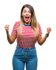 Wall Mural - Young beautiful woman casual look over isolated background celebrating surprised and amazed for success with arms raised and open eyes. Winner concept.