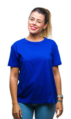 Canvas Print - Young beautiful woman wearing casual blue t-shirt over isolated background winking looking at the camera with sexy expression, cheerful and happy face.