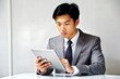 © N7 - Focused Asian Sales Executive with Tablet Device