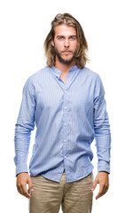 Poster - Young handsome man with long hair over isolated background with serious expression on face. Simple and natural looking at the camera.