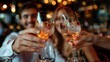 © LifeMedia - A couple raising their glasses for a toast while enjoying a night out at a stylish and cozy restaurant, capturing moments of togetherness and joy with a festive background.