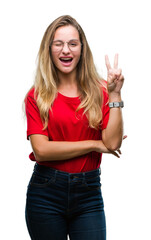 Sticker - Young beautiful blonde woman wearing glasses over isolated background smiling with happy face winking at the camera doing victory sign. Number two.