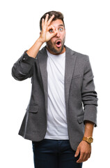 Poster - Young handsome business man over isolated background doing ok gesture shocked with surprised face, eye looking through fingers. Unbelieving expression.