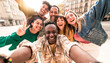 © Davide Angelini - Multiracial best friends taking selfie walking on city street - Happy young people having fun enjoying day out - Diverse teens laughing at camera on summer vacation - Friendship and tourism concept