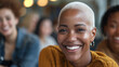 © Sophie  - Happy mixed race woman socialising with colleagues & office friends. Inclusive image of a black female employee with blonde buzzcut