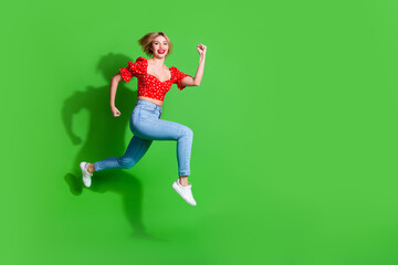 Wall Mural - Photo of positive girl run profile side jump isolated green color background