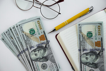 Money dollars, notebook, pen and glasses. Business and success concept