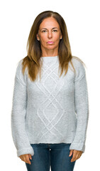 Wall Mural - beautiful middle age adult woman wearing winter sweater over isolated background with serious expres