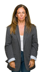 Wall Mural - middle age adult woman wearing oversize boyfriend jacket over isolated background with serious expre