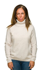 Wall Mural - beautiful middle age adult woman wearing winter sweater over isolated background skeptic and nervous