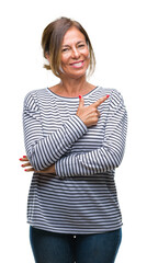 Sticker - Middle age senior hispanic woman over isolated background cheerful with a smile of face pointing with hand and finger up to the side with happy and natural expression on face looking at the camera.