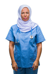 Wall Mural - middle age senior arab nurse woman wearing hijab over isolated background with serious expression on