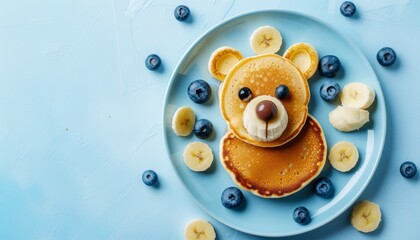 Adorable pancake bear plate for kids on light blue table, top view with space for text