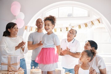 Canvas Print - Girl, happy and family singing for birthday with fun party, applause together and love bonding in home. Young child, smile and song for surprise event with grandparents, parents and celebrate growth