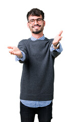 Poster - Young handsome smart man wearing glasses over isolated background looking at the camera smiling with open arms for hug. Cheerful expression embracing happiness.