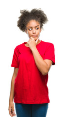 Canvas Print - Young afro american woman over isolated background looking confident at the camera with smile with crossed arms and hand raised on chin. Thinking positive.