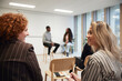 © Johnér - Cheerful corporate colleagues looking at each other during meeting in office