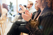 © Johnér - Midsection of young businesswoman applauding during presentation in office