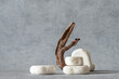© Andrey Nikitin - Empty stone podium, pieces of snag on grey background. Minimalist eco backdrop. Round natural rocks and snags. Pedestal for product advertising. Wabi sabi concept. Copy space, front view.