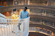 © Johnér - Businessman and businesswoman talking while standing on spiral staircase in office