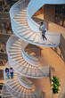 © Johnér - High angle view of colleagues walking on spiral staircase in office