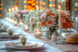 © beldesigne - Elegant wedding table with an off-white tablecloth and delicate cream coloured roses. Pure white plates with sparkling gold cutlery create a luxurious and sophisticated aesthetic. Blurred background