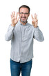 © Krakenimages.com - Handsome middle age elegant senior man wearing glasses over isolated background showing and pointing up with fingers number eight while smiling confident and happy.