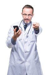 Sticker - Middle age senior hoary doctor man texting using smartphone over isolated background pointing with finger to the camera and to you, hand sign, positive and confident gesture from the front