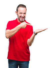 Wall Mural - Middle age hoary senior man over isolated background amazed and smiling to the camera while presenting with hand and pointing with finger.