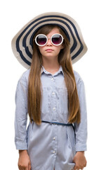 Sticker - Young blonde toddler wearing hat and sunglasses with a confident expression on smart face thinking serious