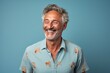 © Markus Schröder - Portrait of a jovial man in his 50s donning a trendy cropped top on soft blue background