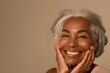 © LukaszDesign - Smile, joyful, and senior woman portrait with hair, skin, and wellbeing on grey mockup studio background. Elderly model's health, skincare, and face with makeup pleasure in retirement