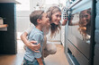 © Oostendorp/peopleimages.com - Mother, baking and boy or house oven, child development and helping in kitchen together with dessert or cookies. Happiness, childhood and fun activity with stove, teaching and bonding in apartment