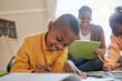 © peopleimages.com - Boy, black child and writing in living room for homework, learning literature or education. Family, young kids with woman parent on floor for teaching, growth development or bonding together in home