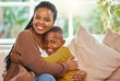 © peopleimages.com - Portrait hug, black family and mom with son for bonding, love and smile for support on home sofa. African mother, young boy and happy embrace in living room for weekend, trust and relationship care