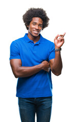 Wall Mural - Afro american man over isolated background with a big smile on face, pointing with hand and finger to the side looking at the camera.